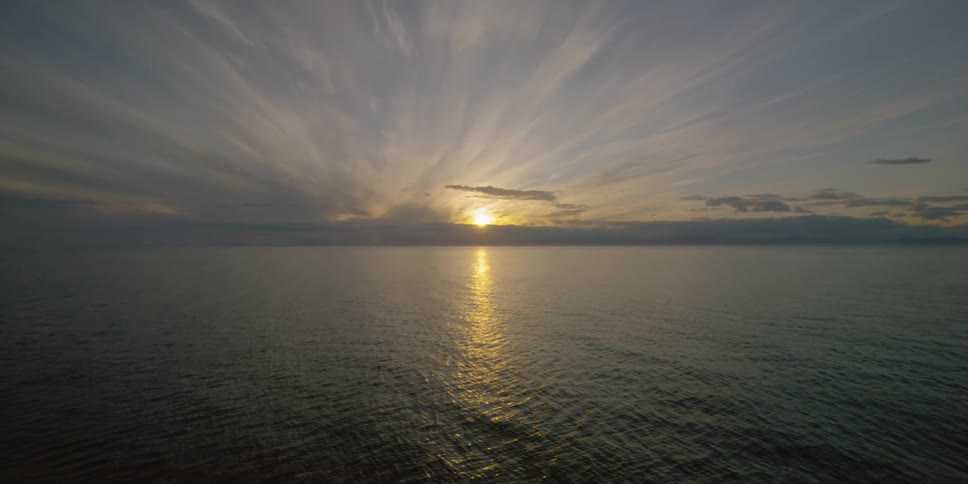 The sun is setting out over the ocean