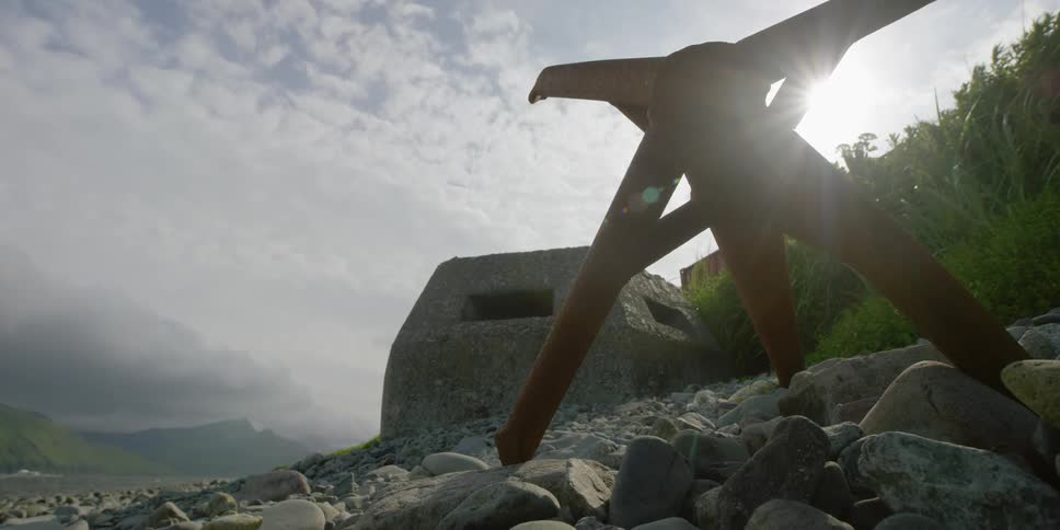 A large anchor on a beach