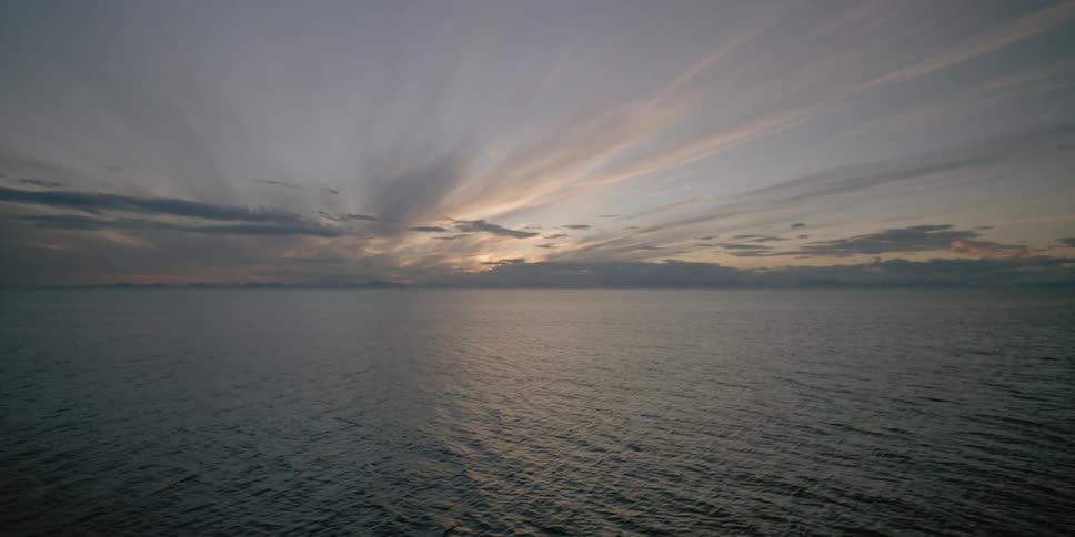 The sun sets over the ocean