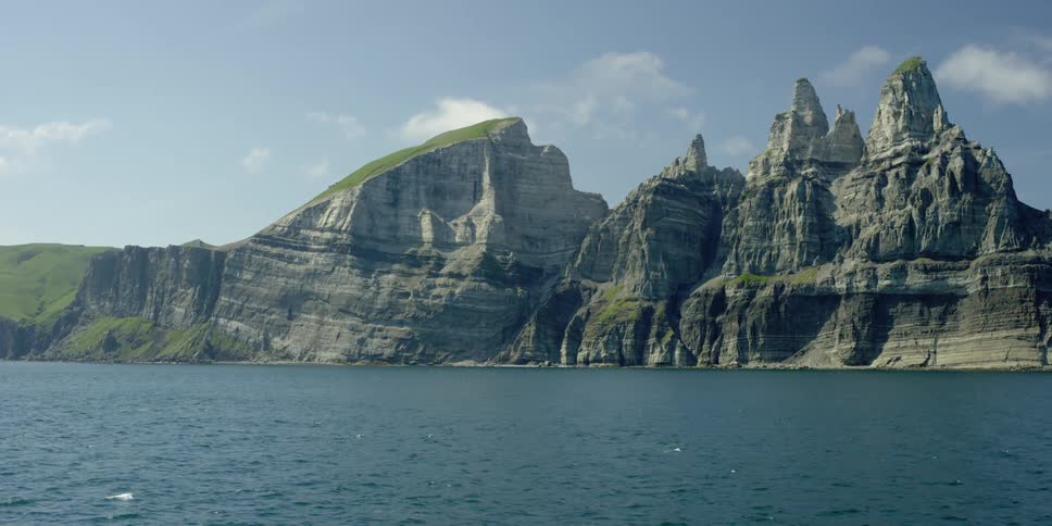 Water flows in front of rocky cliffs