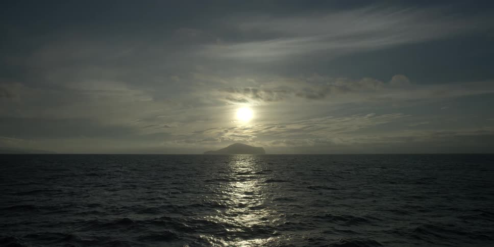 The sun over the ocean and island