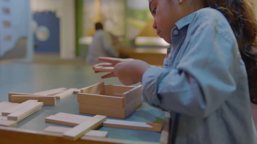 A child is building with wood