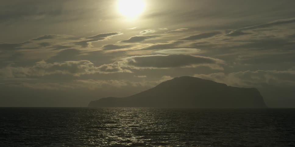 The sun shines brightly onto the ocean water