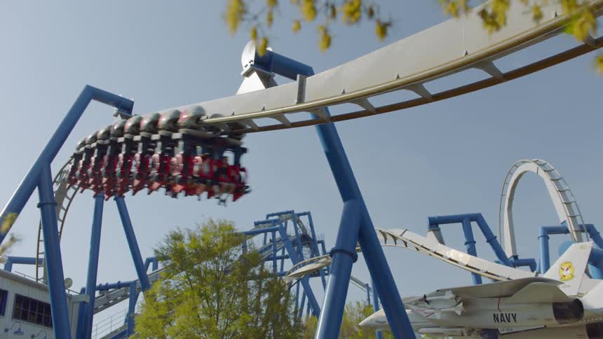 A roller coaster in a theme park is running