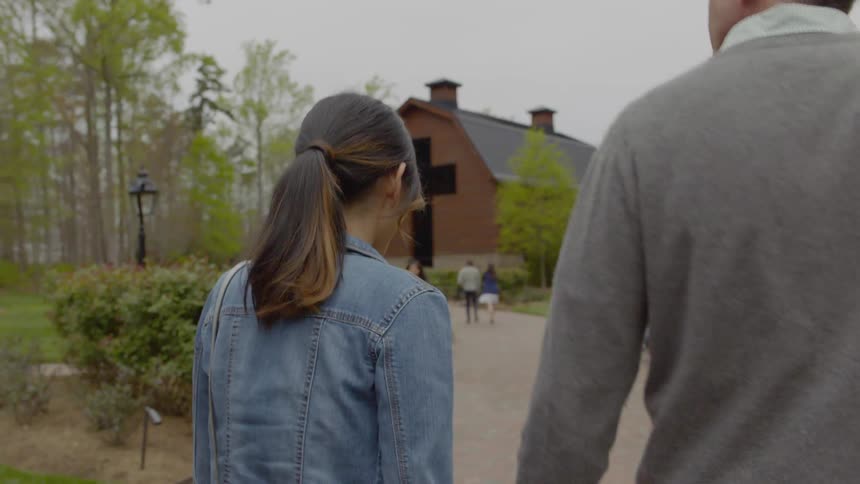 A man and woman walk towards a church building