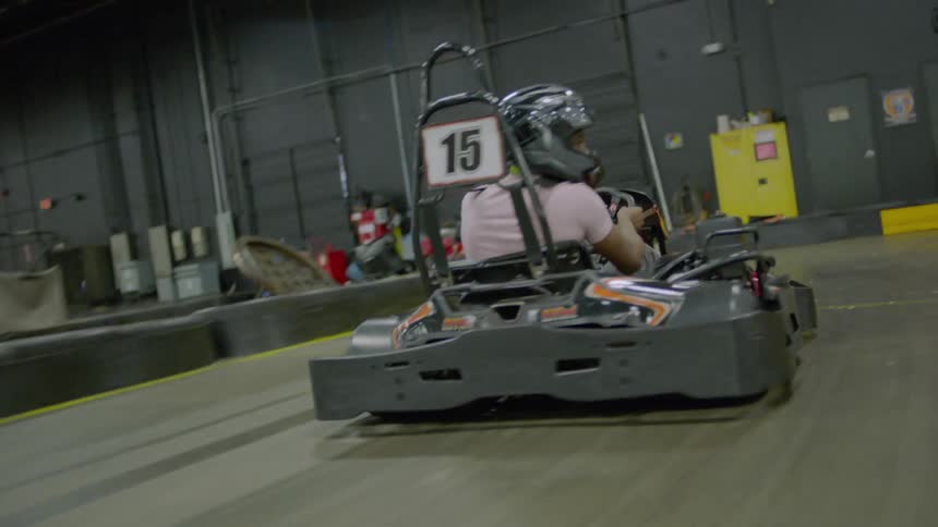 A man is riding a go kart around the track