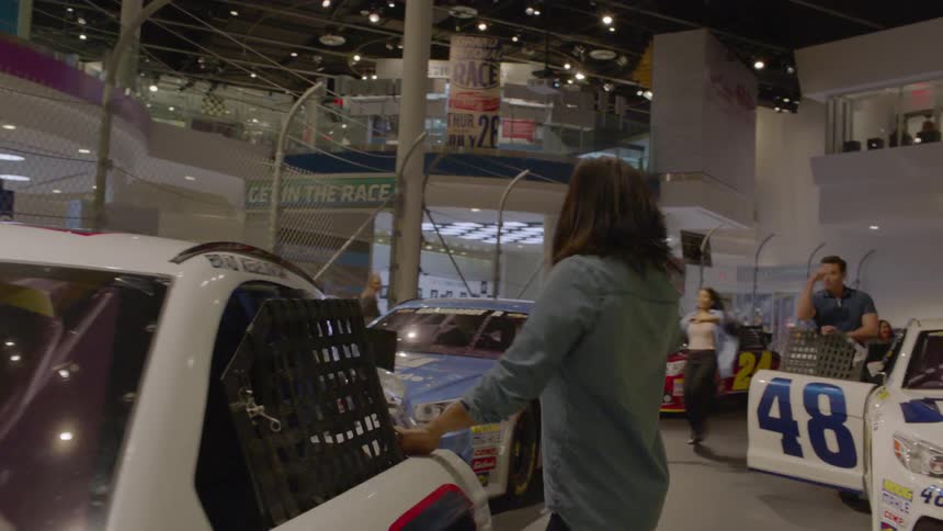 People run and climb into race cars