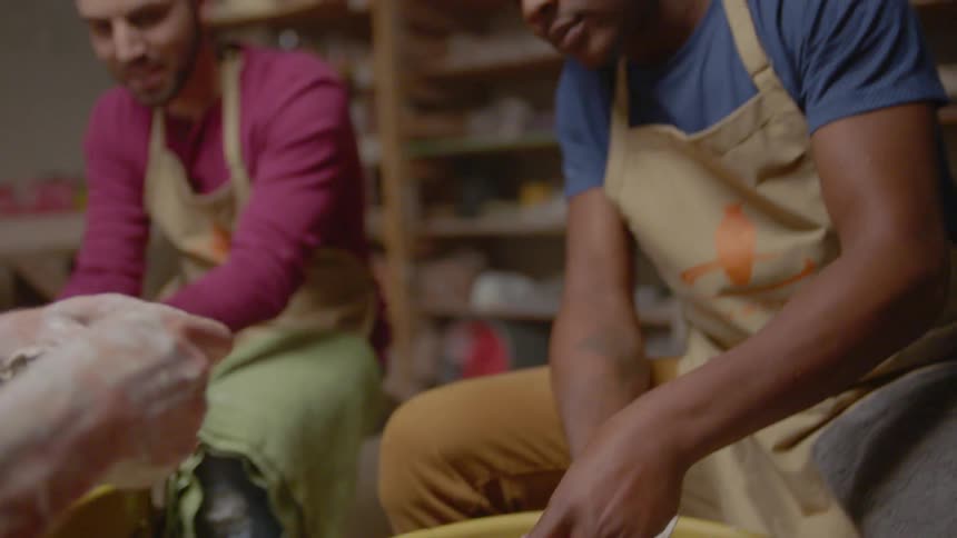 Two men create pottery together