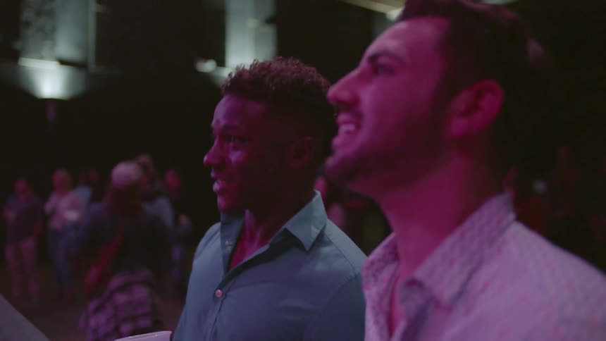 Two men talking at a performance