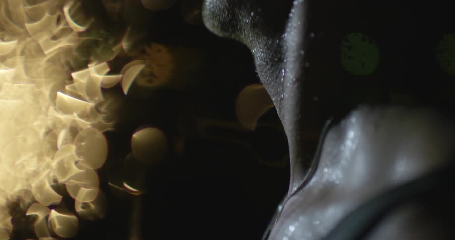 A man is covered in sweat outside at night