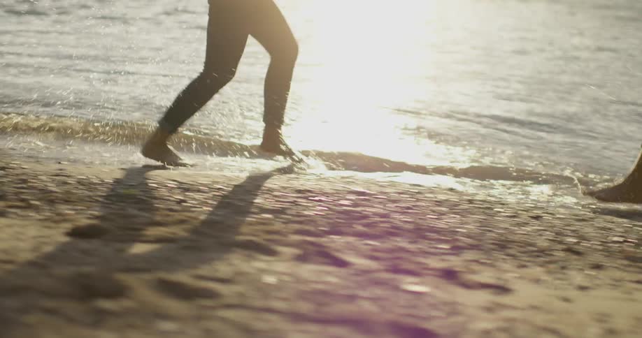 Girlfriends run and laugh on the beach
