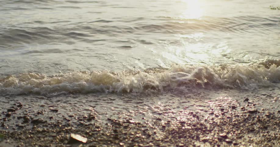 Waves coming ashore at sunset