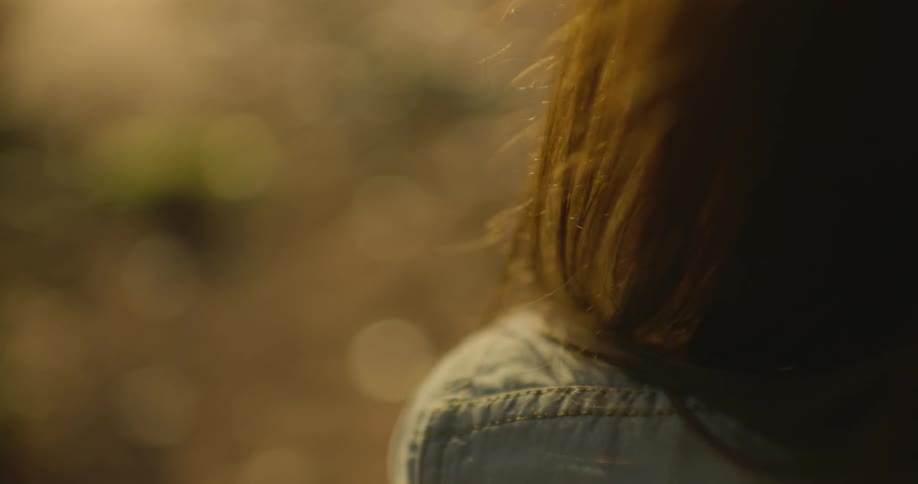 A brunette woman sitting outside