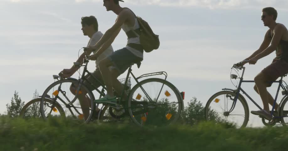 A group of friends ride their bikes on a sunny day