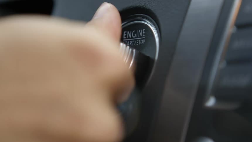 A person puts their key in the car ignition