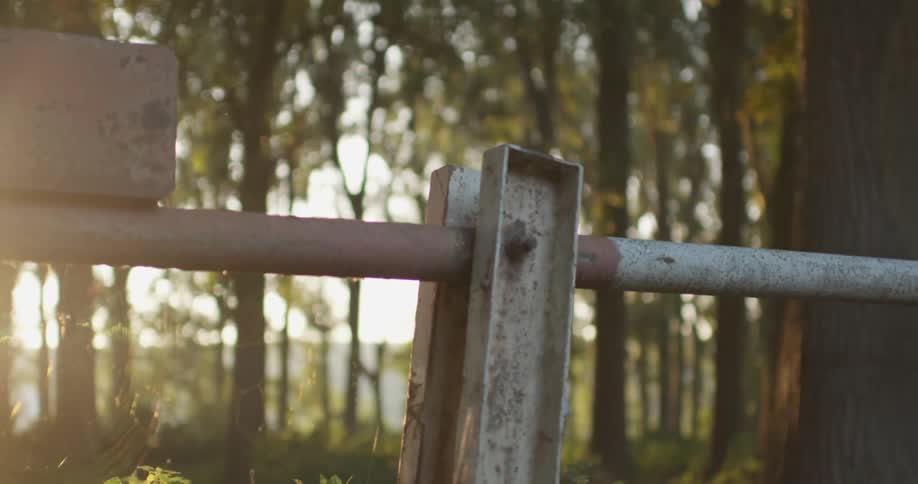 A man jumps over a metal railing