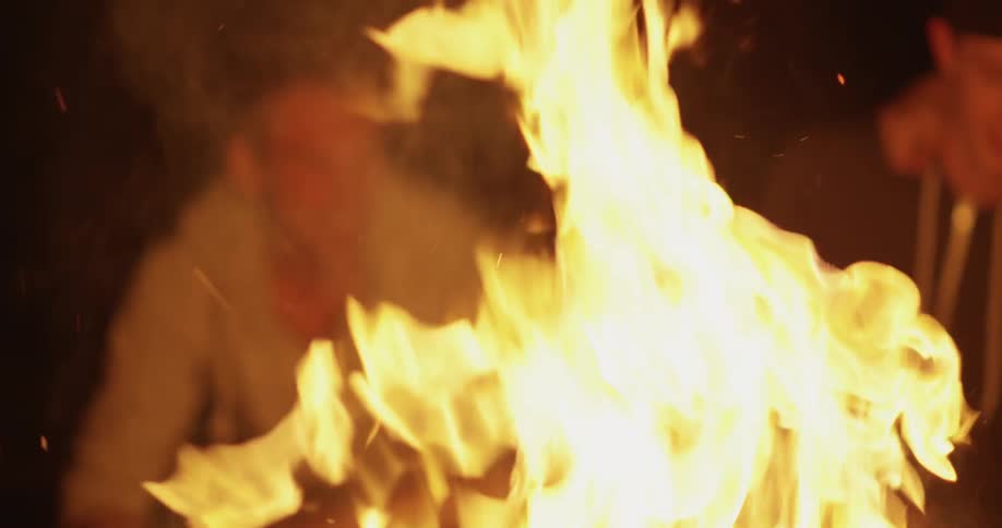 People sit in front of a fire