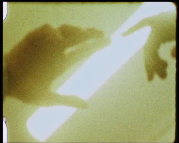 Two hands touch beneath a fluorescent light