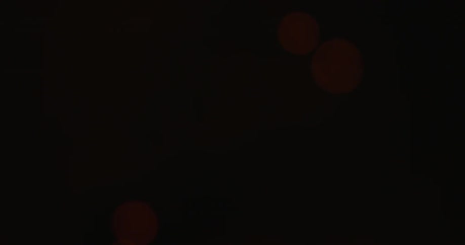 Sparks are rising up from a campfire at night