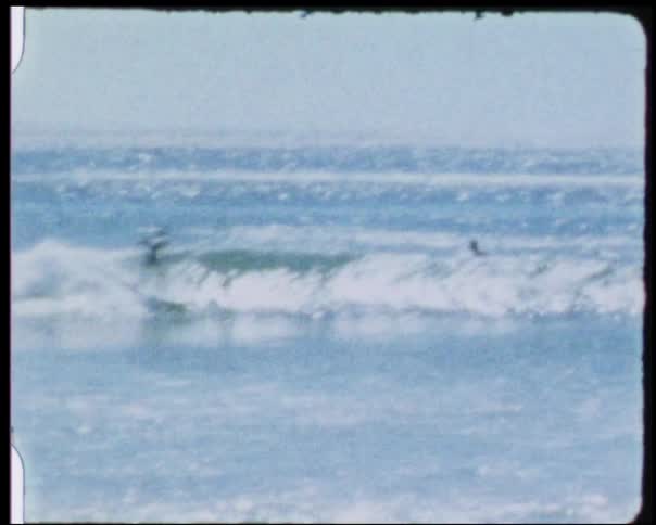 A surfer rides a wave