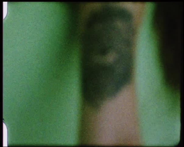 A mans tattooed arm hangs over the side