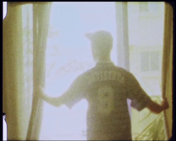 A man pulls open curtains