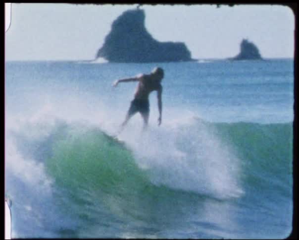 A surfer is riding a wave on a sunny day