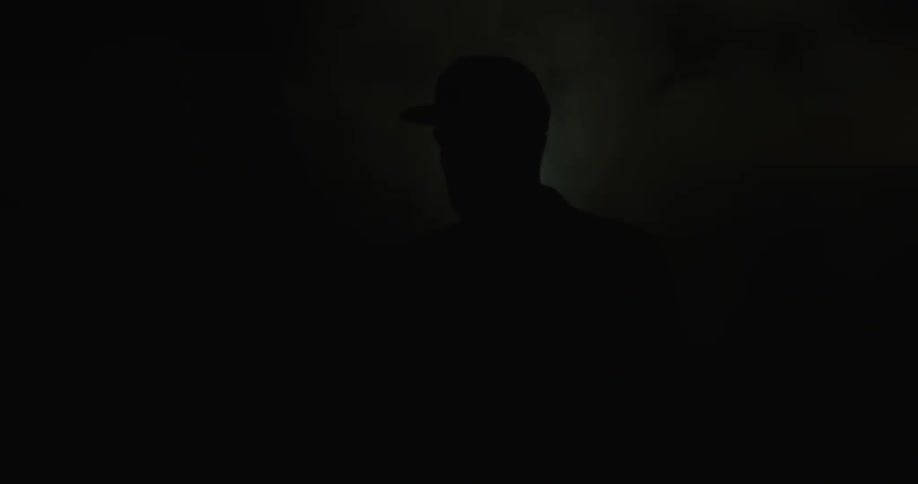 A man stands out in the dark in the haze