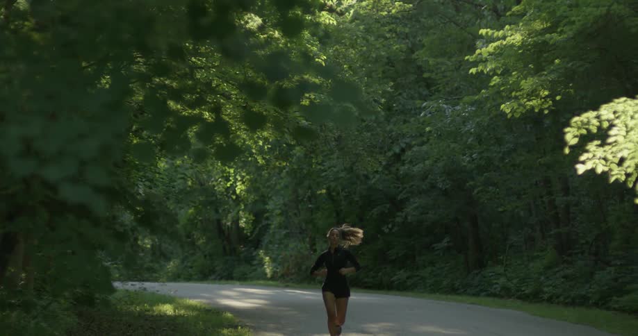 A woman is jogging around the road