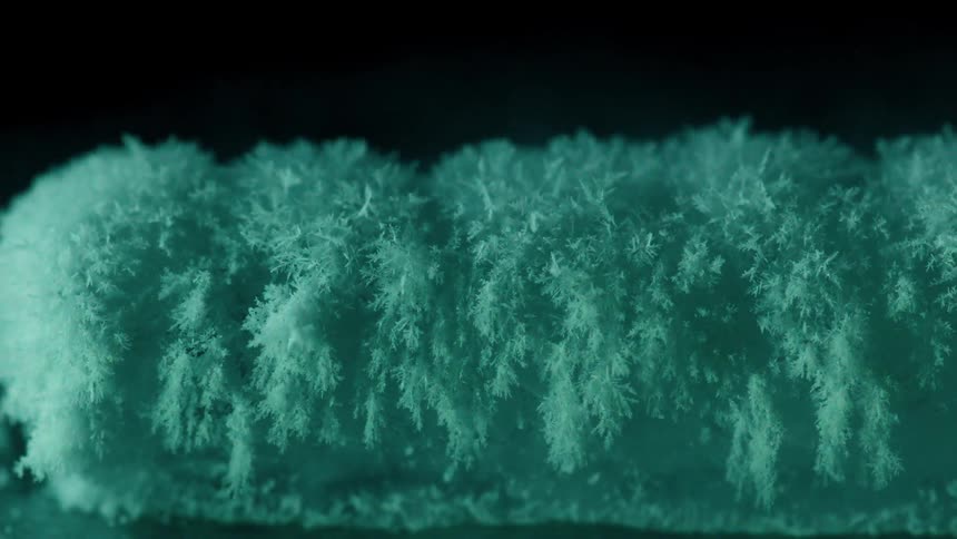 Crystals are forming on a surface in abstract