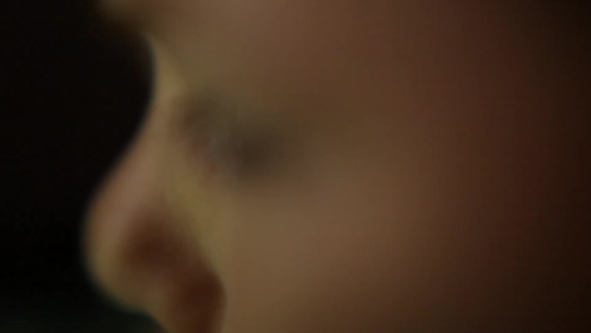 A toddler is blinking their eyes during the day
