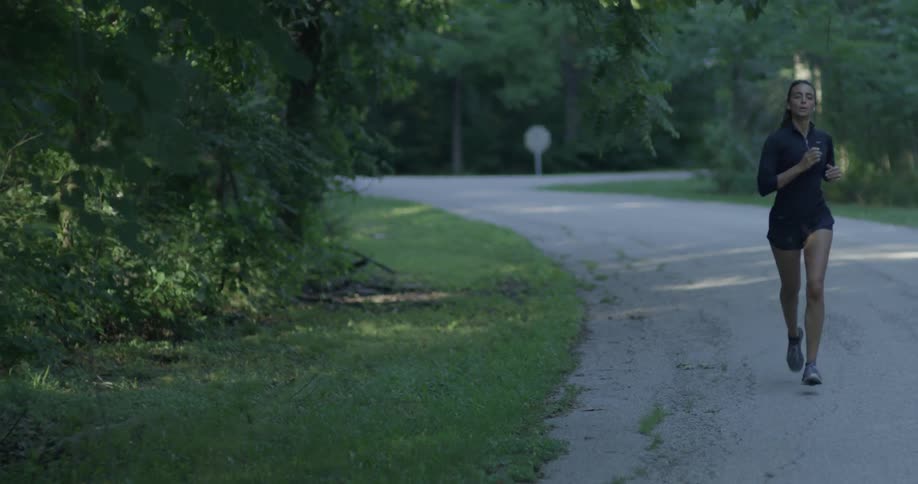 A woman jogs down a rural road