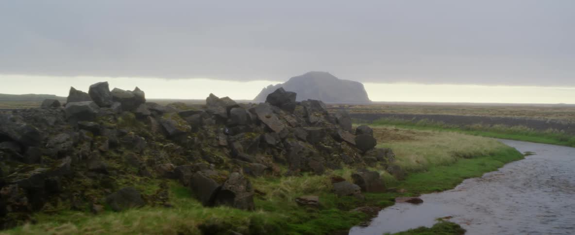 Rock formations sit beside a small stream