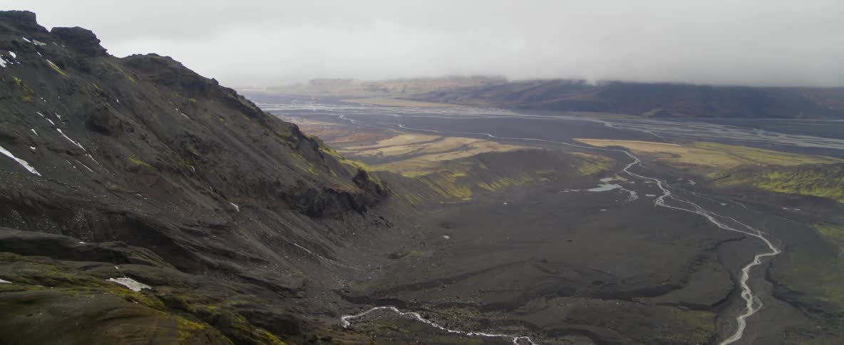 A narrow stream flows from a rocky slope