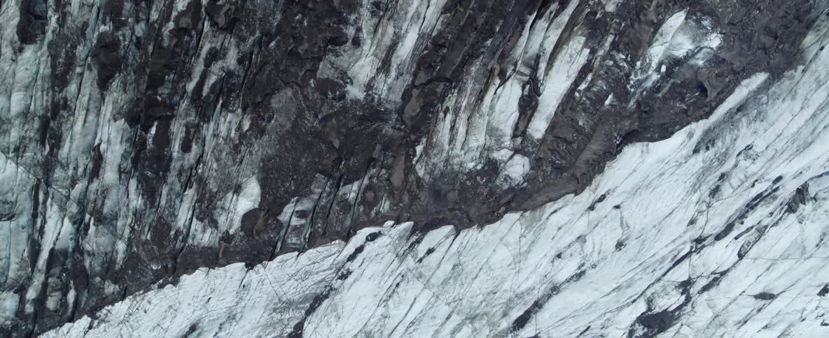 Snow covers a rocky mountainside