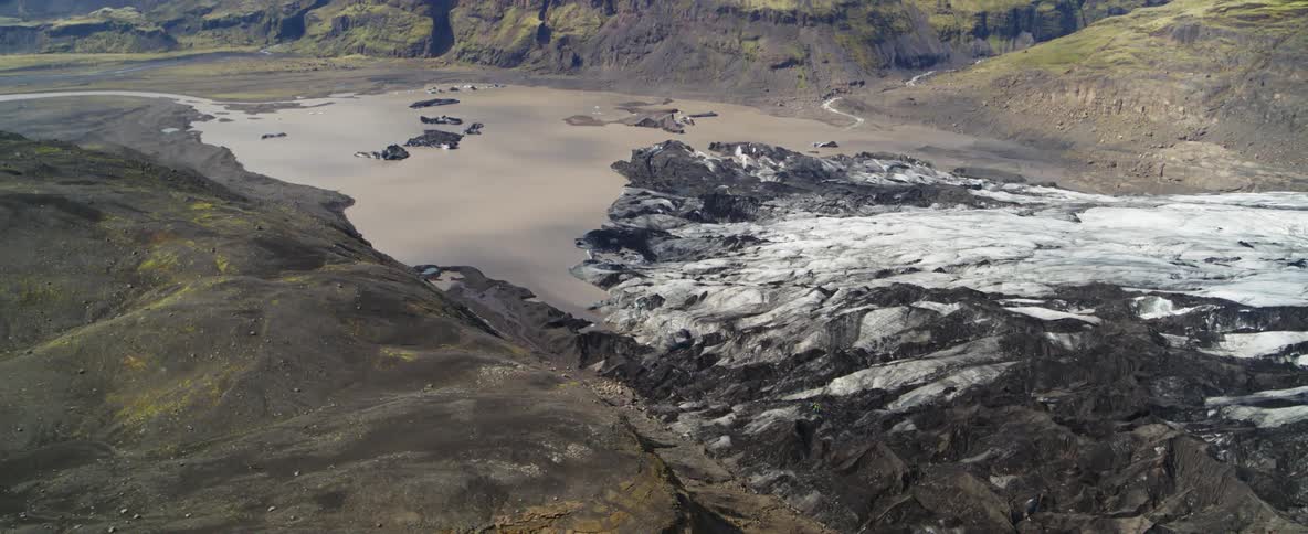 Muddy snow covers a mountain landscape