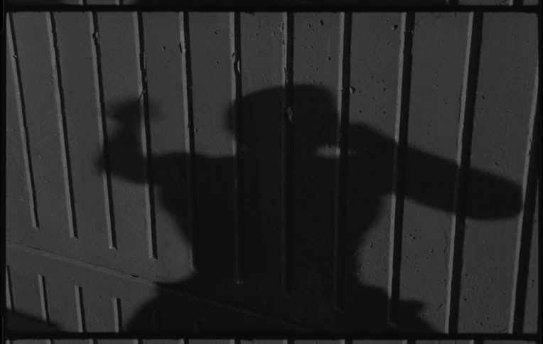 A man shadow boxes in the dark