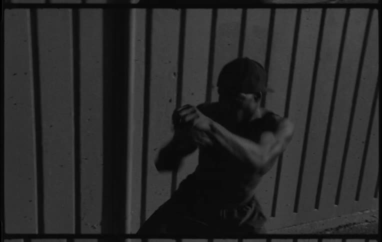 A fighter is shadow boxing outside at night