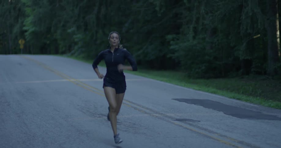 A woman jogs down the road