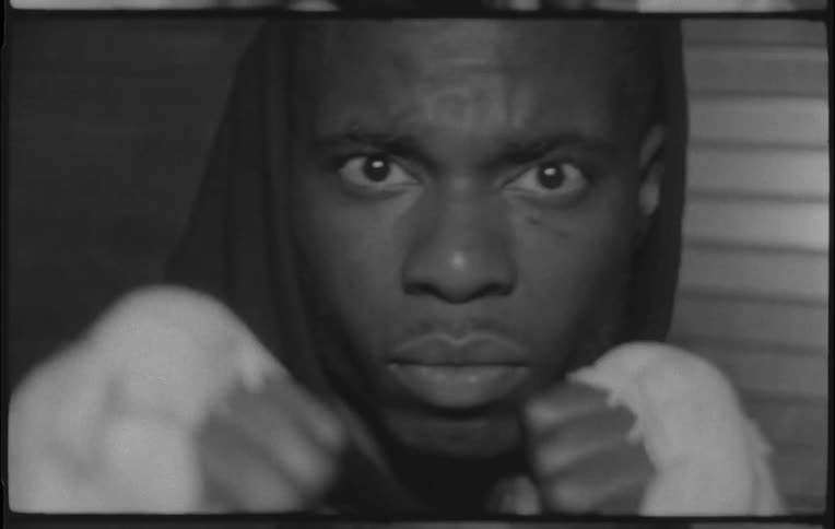 A fighter is shadow boxing in front of a door