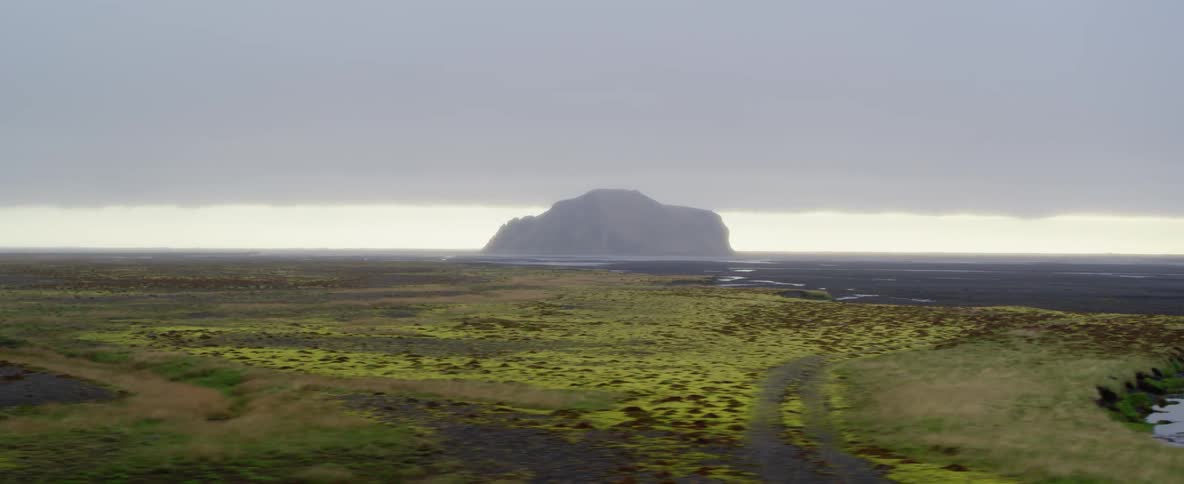 Clouds hover over an island at sunset