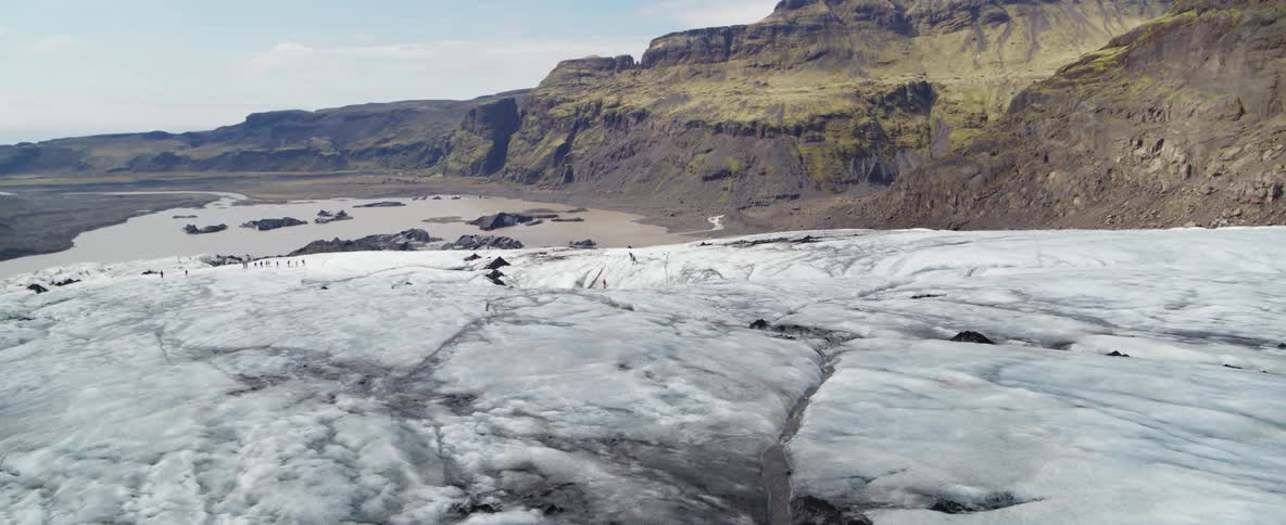 Gray and white ice near a mountain