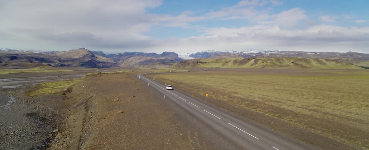 A car drives down an empty road