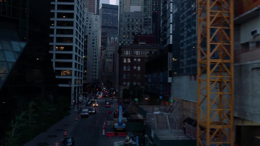 Cars drive on a city street