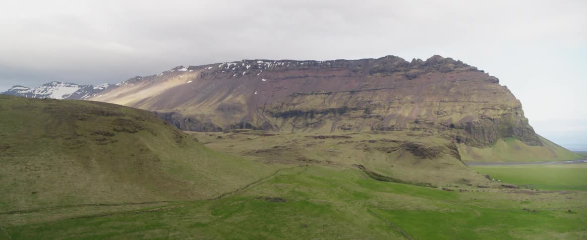 A mountain valley is shown on a cloudy day