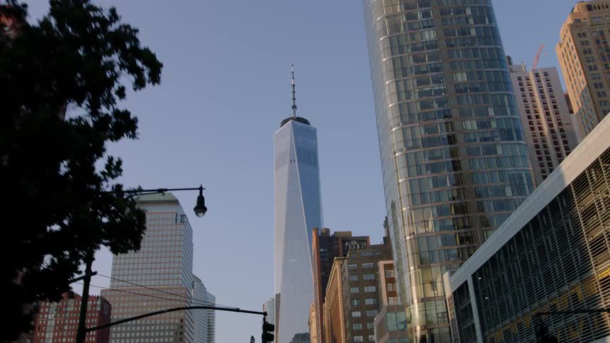 Skyscrapers tower above a city street at dawn