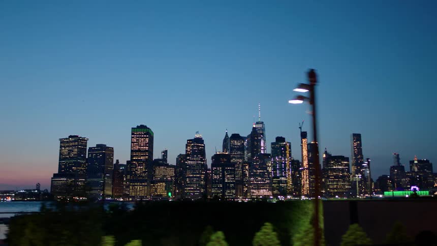 The city over the water is brightly lit at sunset