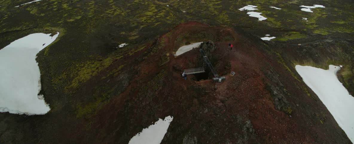 A structure and a pit dug into a mountainside