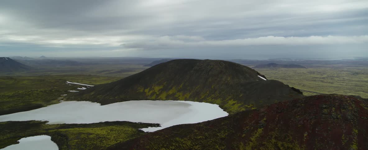 Patches of snow cover the ground in the mountains