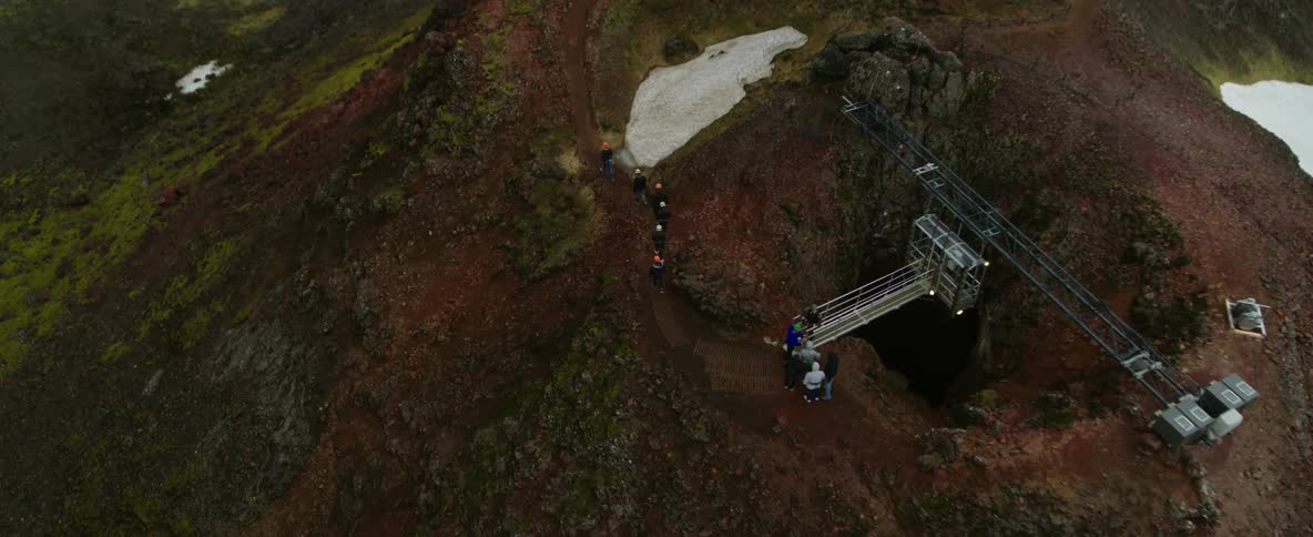 Hikers walk on a mountain peak